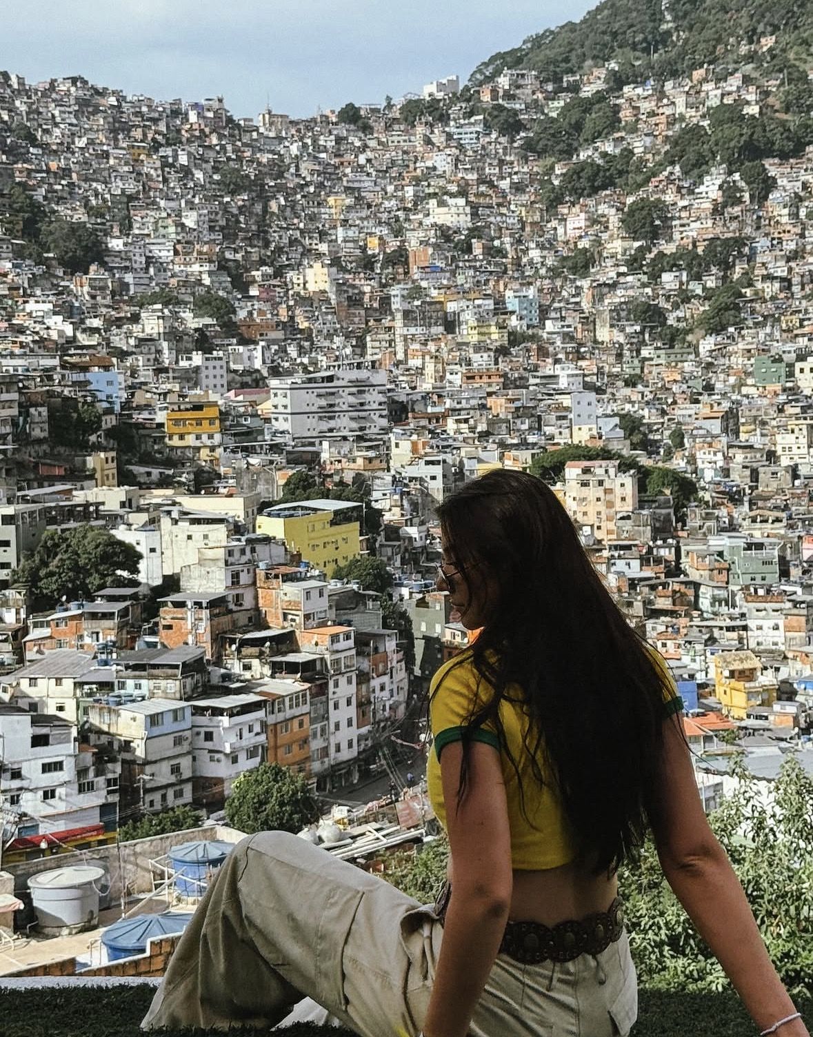 Traveller wearing comfortable shoes and a small backpack walking through a colourful favela alleyway in Rio